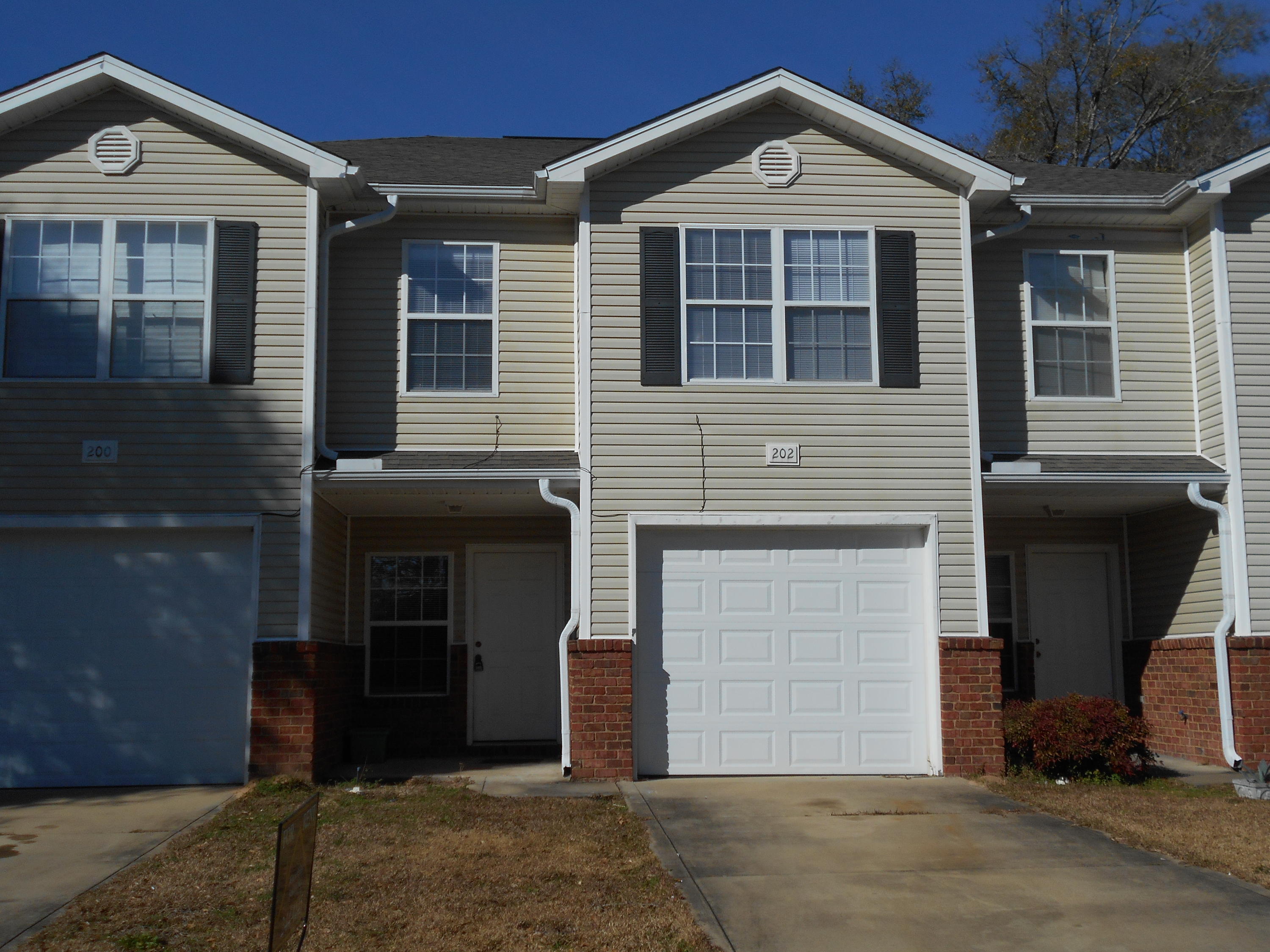 202 Johnson Court Crestview, FL 32536 - Photo 1 of 24 a front view of a house with a yard and garage