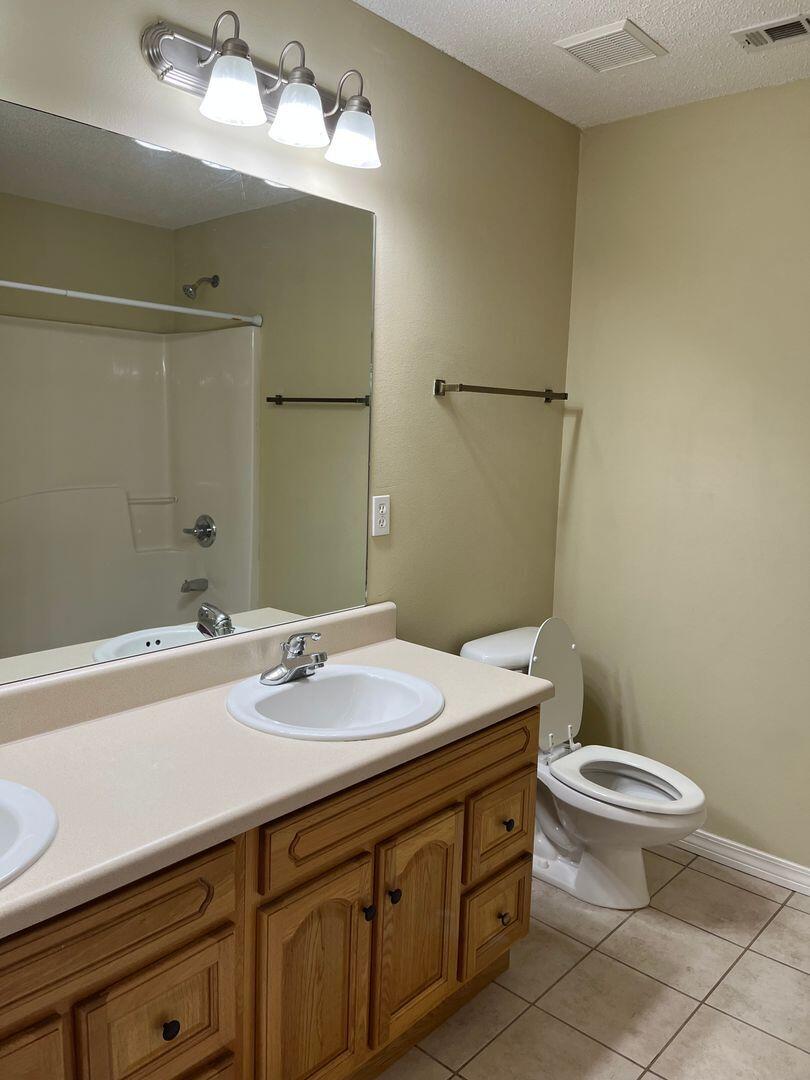 202 Johnson Court Crestview, FL 32536 - Photo 13 of 24 a bathroom with a sink a toilet and shower