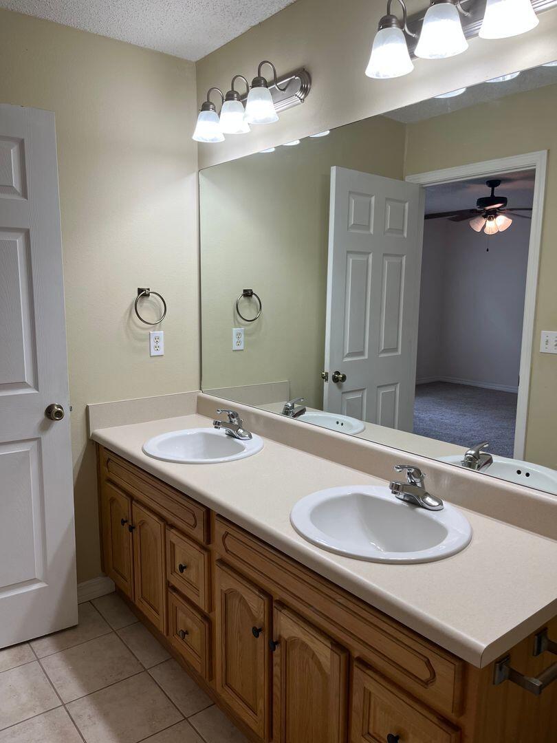 202 Johnson Court Crestview, FL 32536 - Photo 14 of 24 a bathroom with a sink double vanity and a mirror