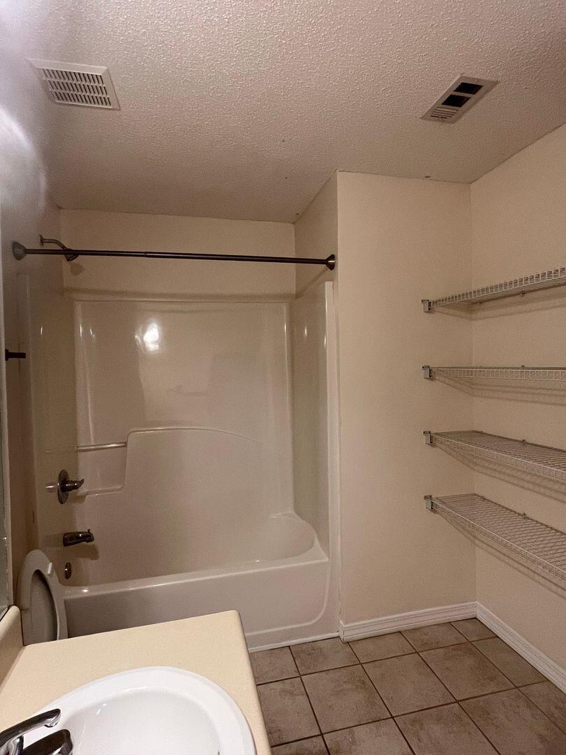 202 Johnson Court Crestview, FL 32536 - Photo 19 of 24 a bathroom with a bathtub and a shower