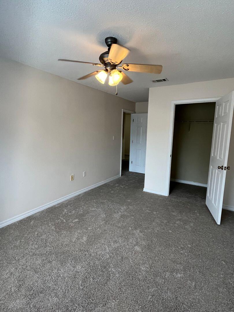 202 Johnson Court Crestview, FL 32536 - Photo 20 of 24 a view of a hallway with a chandelier