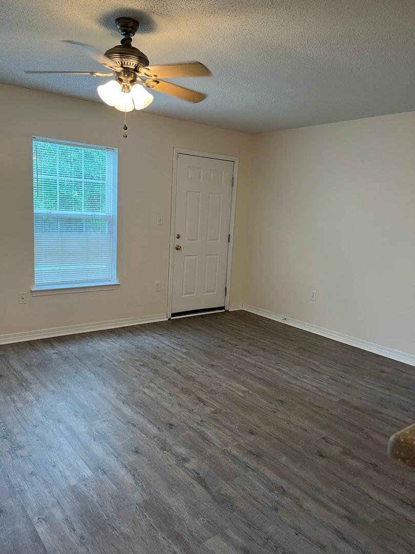 202 Johnson Court Crestview, FL 32536 - Photo 24 of 24 a view of an empty room with wooden floor and a window
