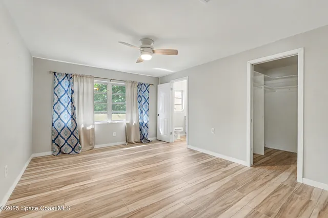 a view of a livingroom with wooden floor and a window