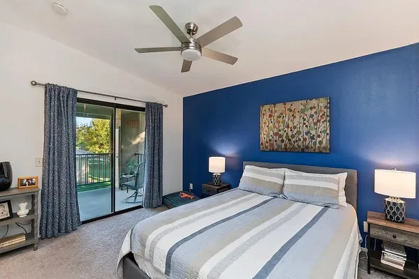 a bedroom with a large bed and a large window