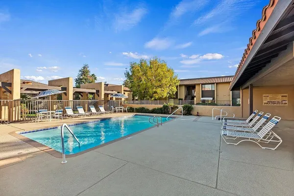 a view of a patio with couches table and chairs and potted plants
