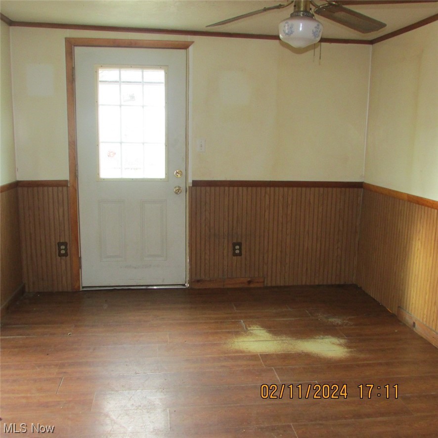 2194 South Leavitt Road Southwest Warren, OH 44481 - Photo 8 of 10 Empty room featuring crown molding, wood-type flooring, and ceiling fan