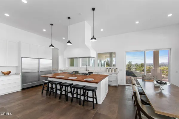 a large kitchen with a table and chairs