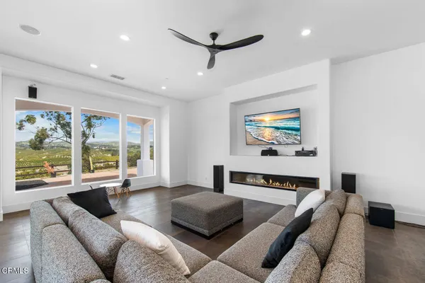 a living room with furniture and a view of kitchen