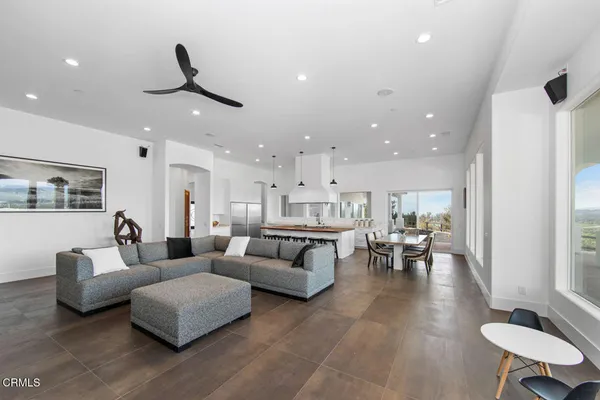 a view of a livingroom with furniture hardwood floor and a ceiling fan
