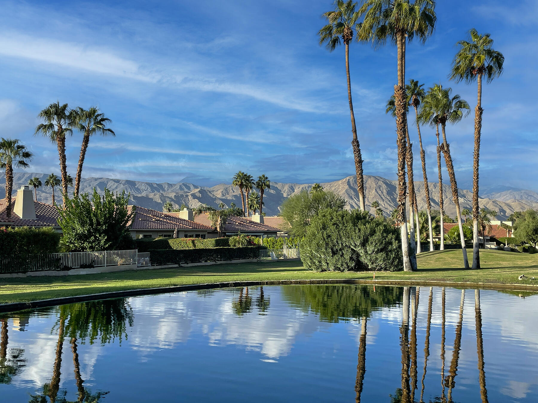 a view of a lake with a house in the background