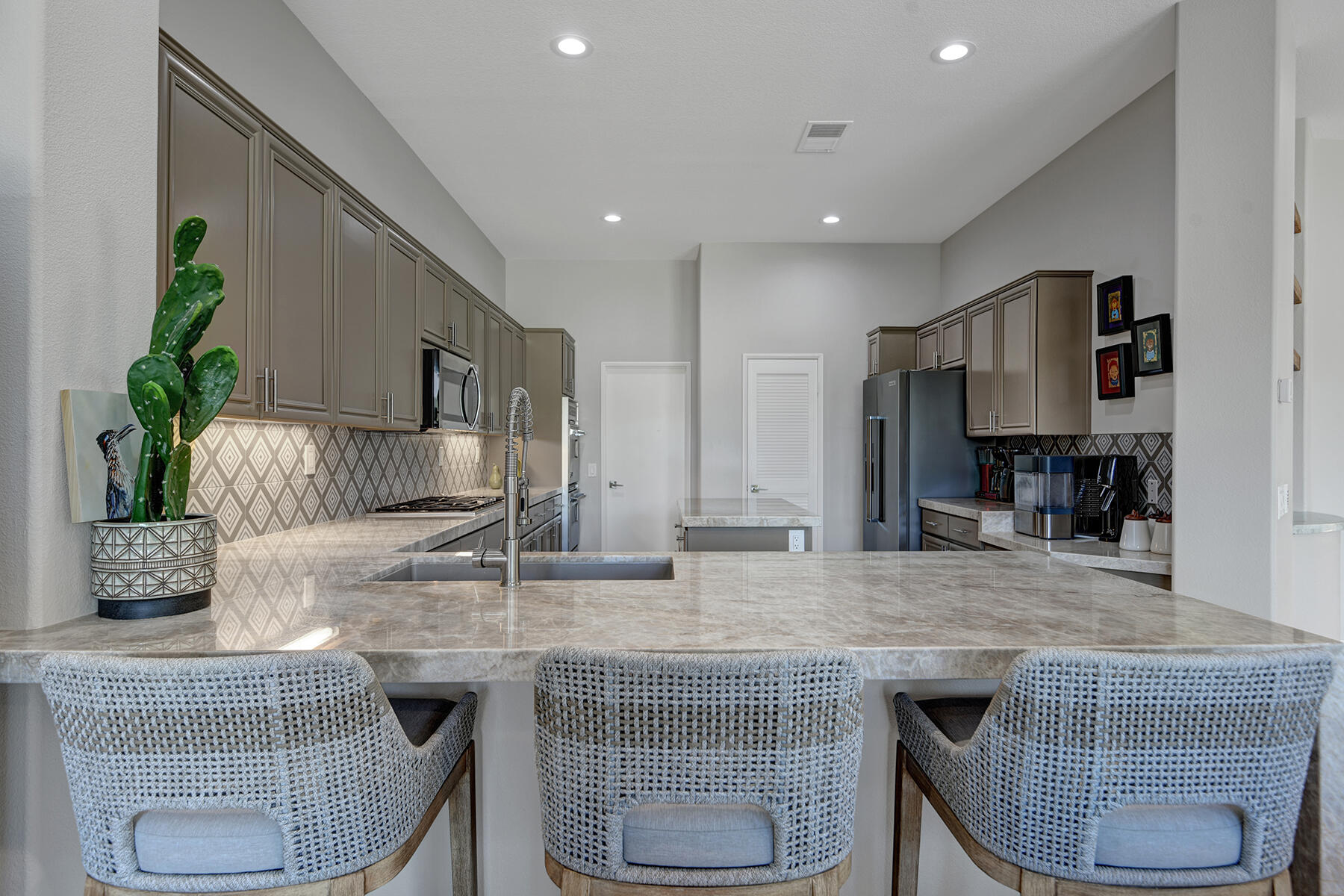 75 North Kavenish Drive Rancho Mirage, CA 92270 - Photo 12 of 41 a kitchen with granite countertop kitchen island stainless steel appliances a sink and counter space