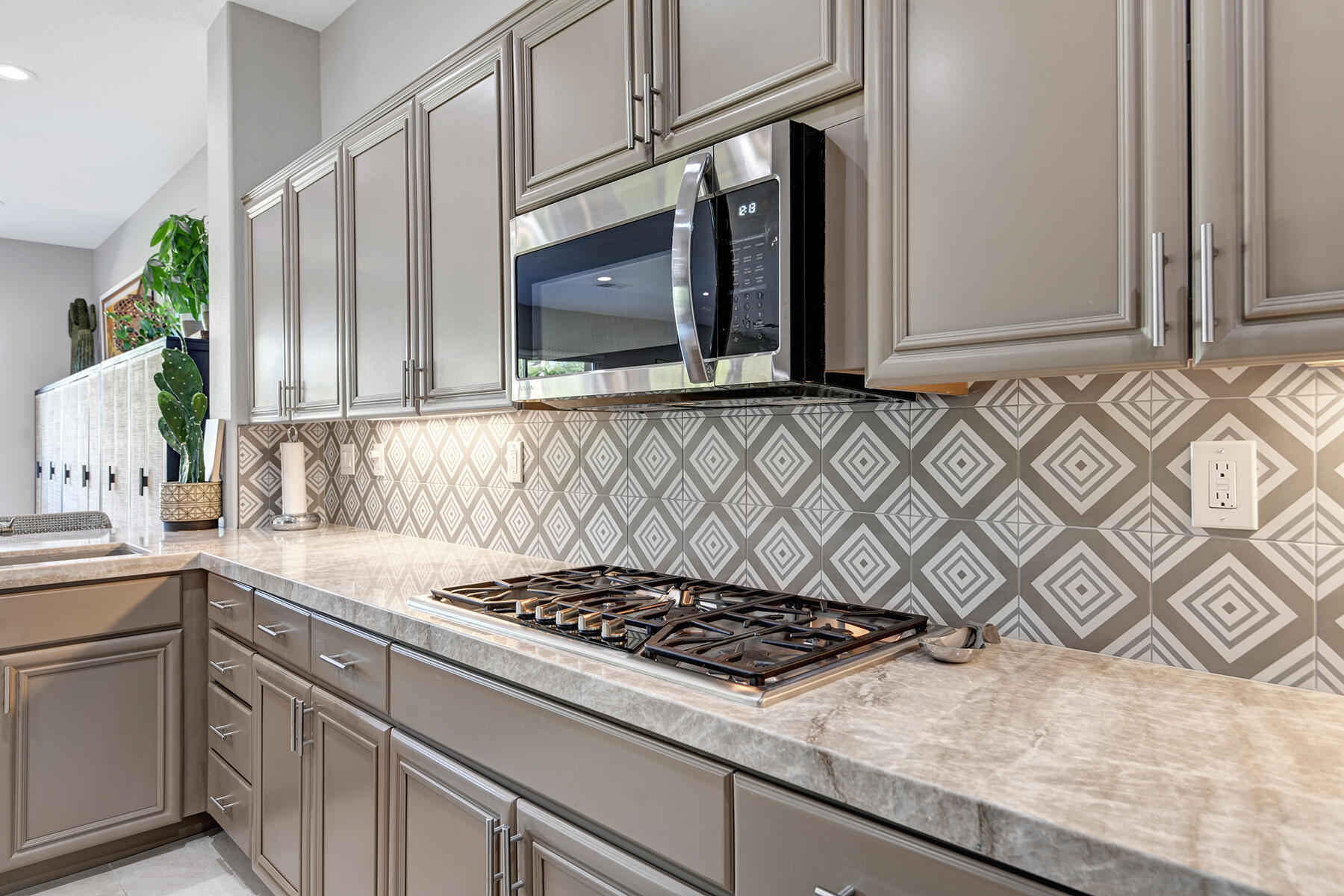 75 North Kavenish Drive Rancho Mirage, CA 92270 - Photo 14 of 41 a kitchen with granite countertop a sink stove and cabinets