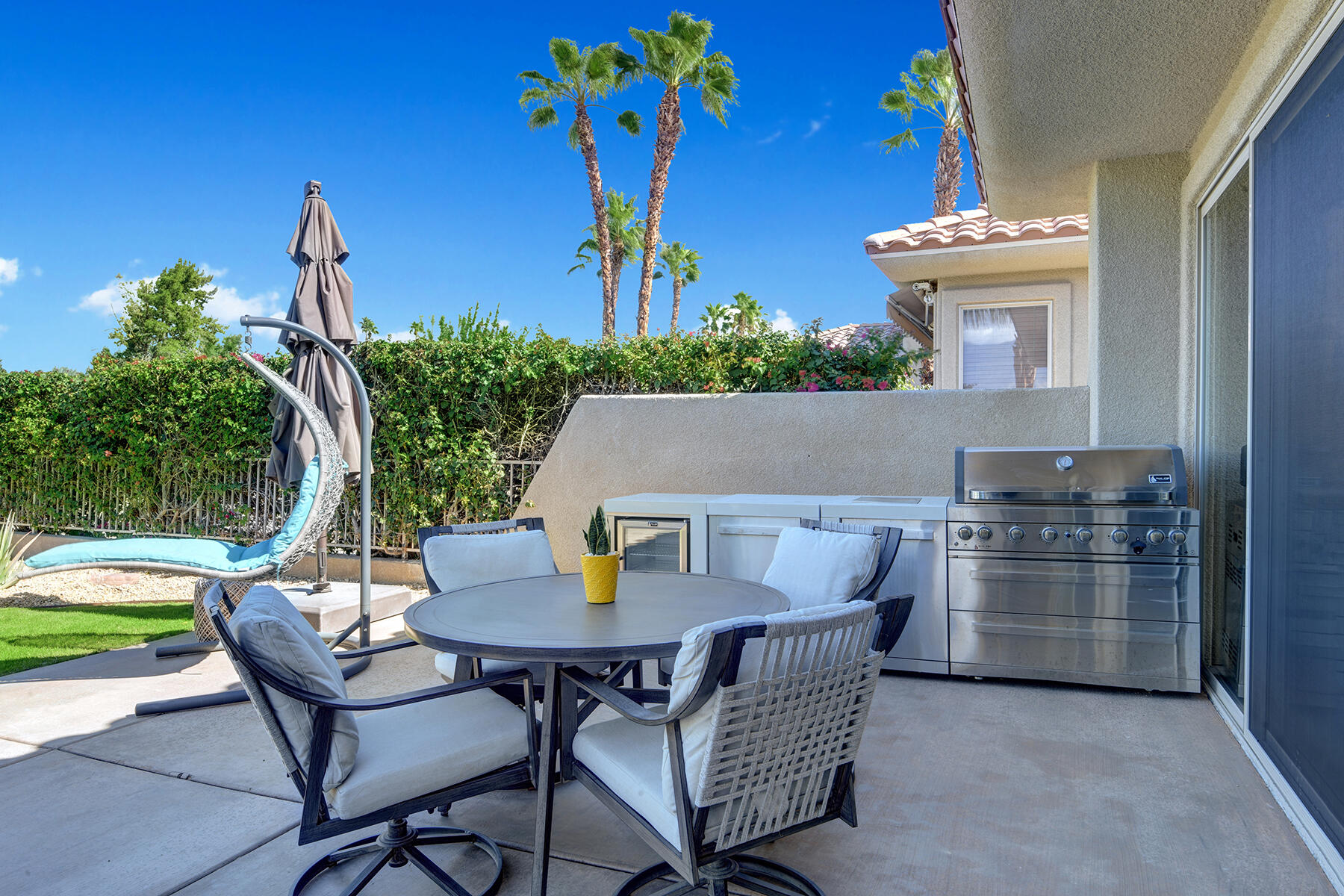 75 North Kavenish Drive Rancho Mirage, CA 92270 - Photo 32 of 41 a view of outdoor dining space with a table and chairs