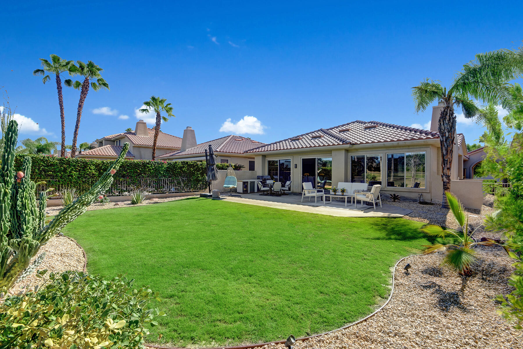 75 North Kavenish Drive Rancho Mirage, CA 92270 - Photo 33 of 41 a view of a house with a backyard patio and swimming pool