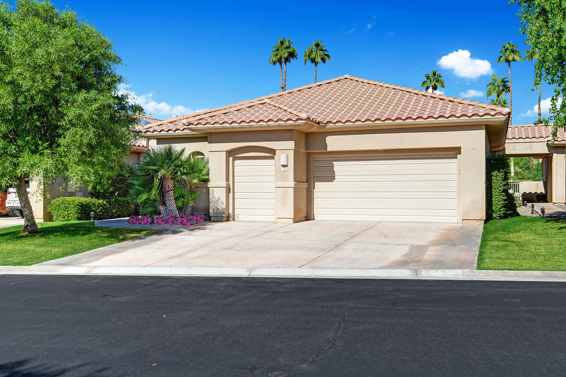 75 North Kavenish Drive Rancho Mirage, CA 92270 - Photo 38 of 41 a front view of a house with a yard and garage