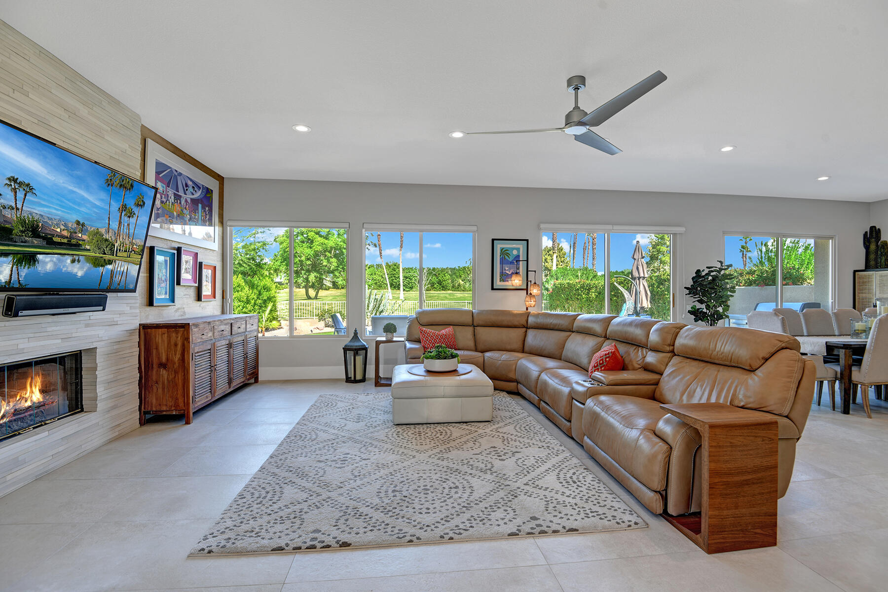 75 North Kavenish Drive Rancho Mirage, CA 92270 - Photo 5 of 41 a living room with furniture flat screen tv and a fireplace