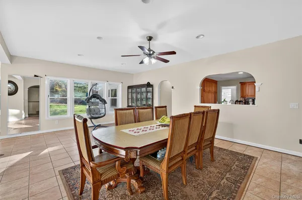 a view of a dining room with furniture and a chandelier
