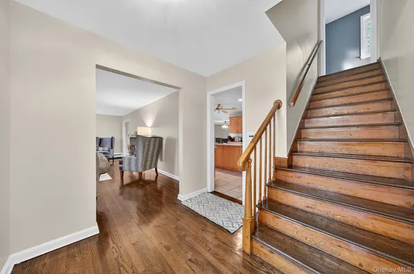 a view of entryway livingroom and hall with wooden floor