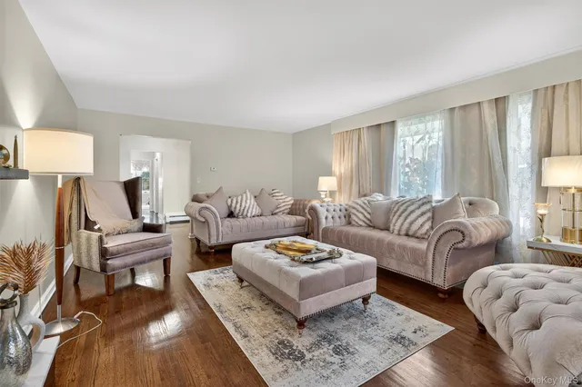 a living room with furniture and a lamp