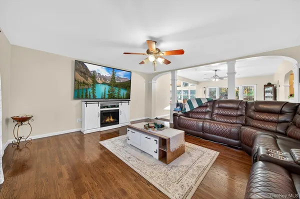 a living room with furniture a flat screen tv and a fireplace