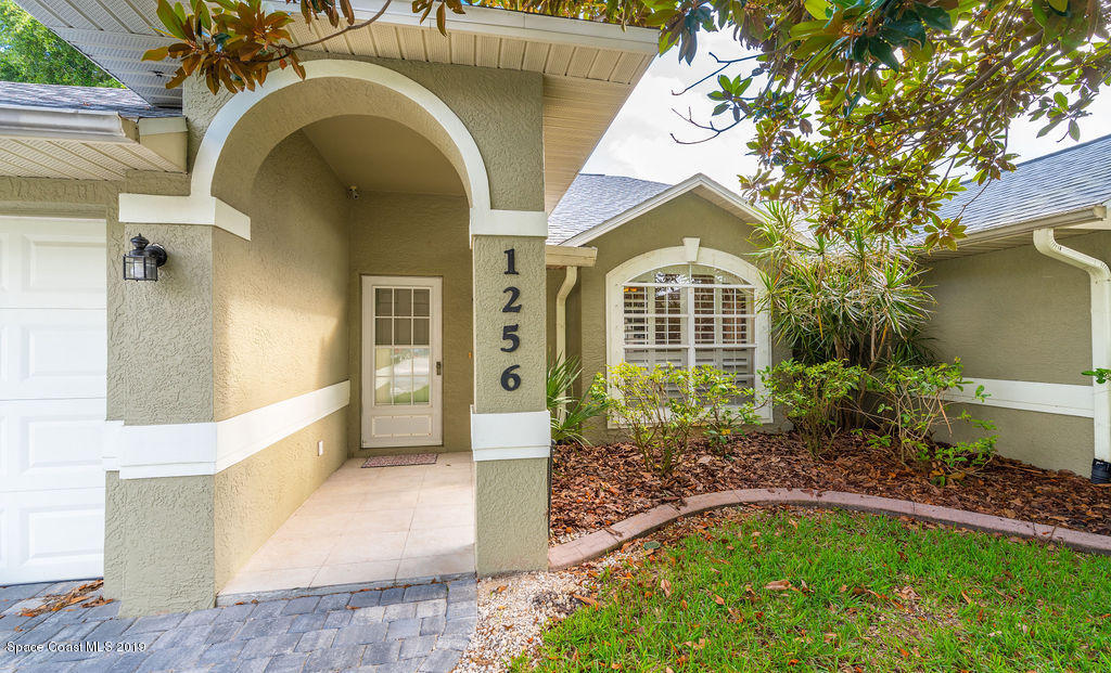 1256 Winding Meadows Road Rockledge, FL 32955 - Photo 2 of 23 a front view of a house with garden
