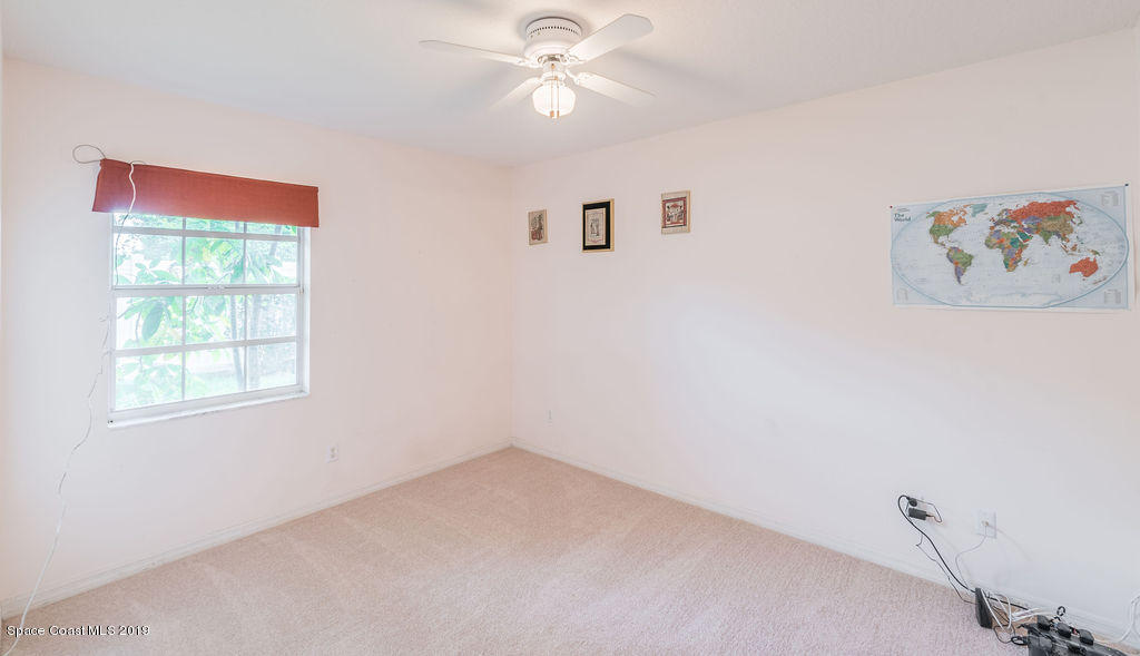 1256 Winding Meadows Road Rockledge, FL 32955 - Photo 16 of 23 an empty room with a window and a fan