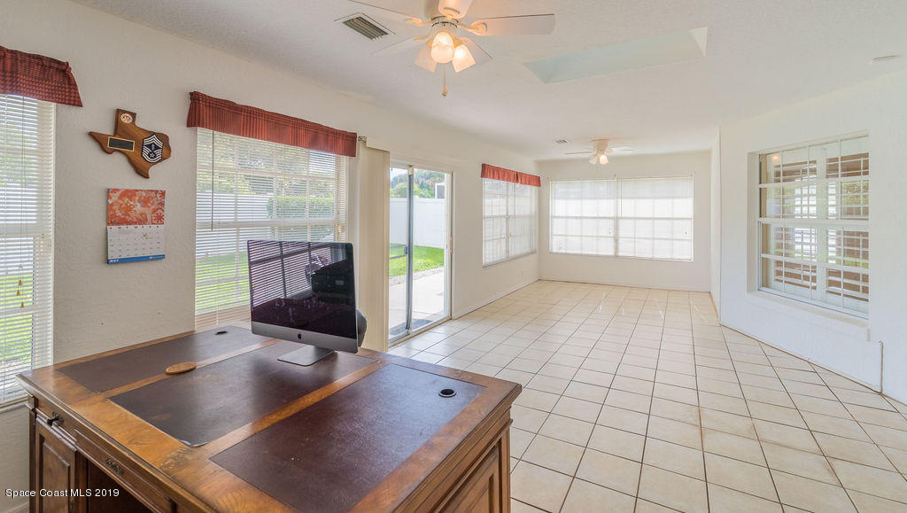 1256 Winding Meadows Road Rockledge, FL 32955 - Photo 17 of 23 a living room with furniture and a table