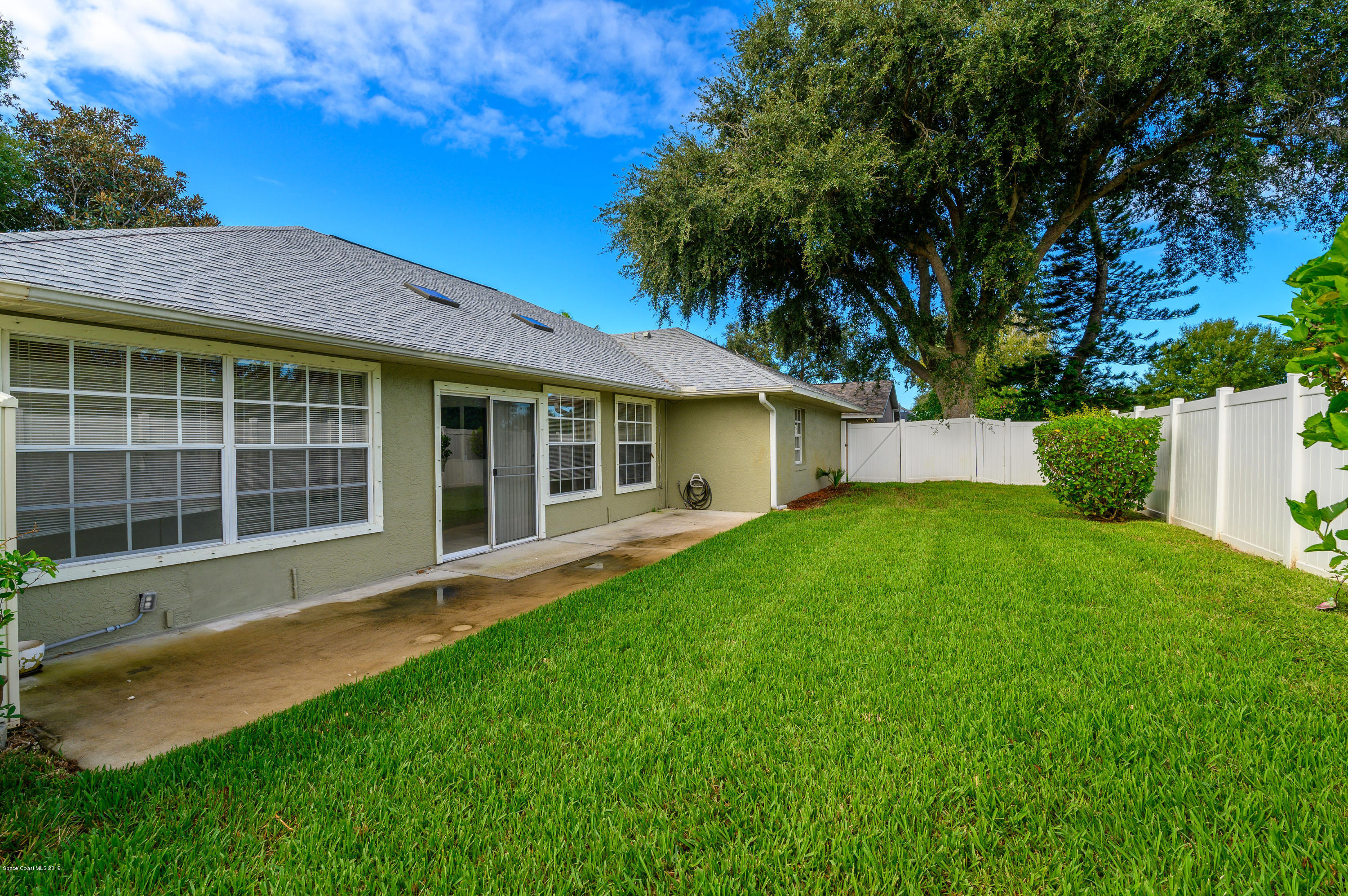 1256 Winding Meadows Road Rockledge, FL 32955 - Photo 20 of 23 a front view of a house with a garden and yard