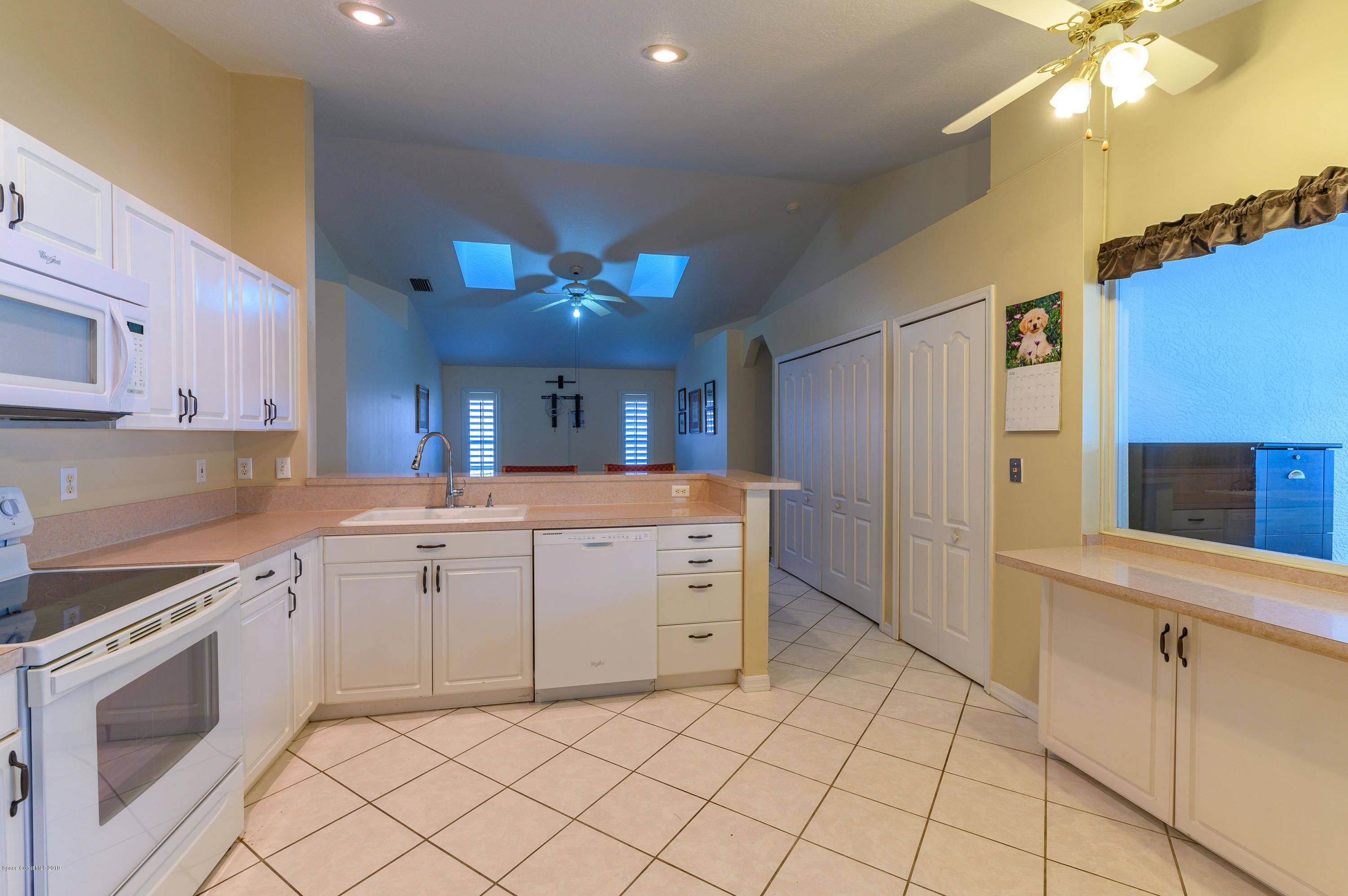 1256 Winding Meadows Road Rockledge, FL 32955 - Photo 4 of 23 a kitchen with cabinets and window