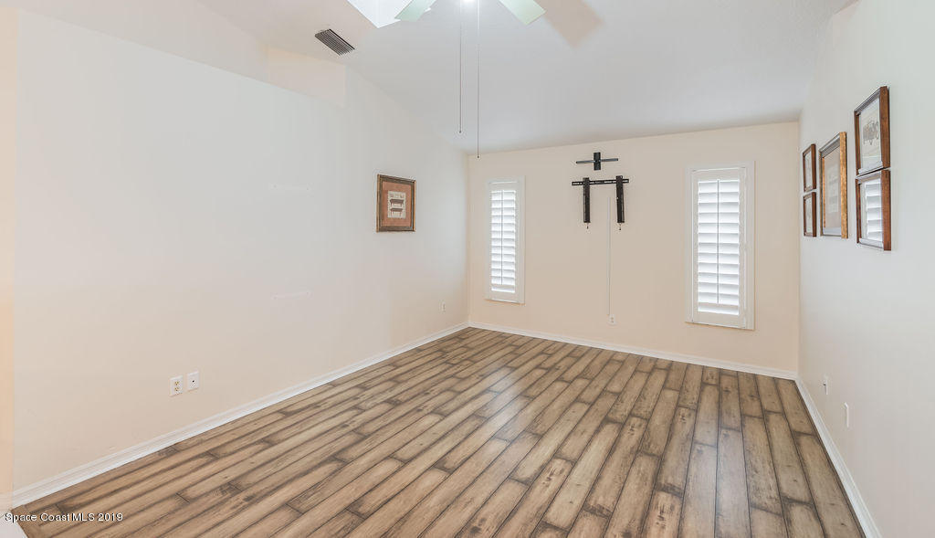 1256 Winding Meadows Road Rockledge, FL 32955 - Photo 8 of 23 a view of empty room with wooden floor and fan