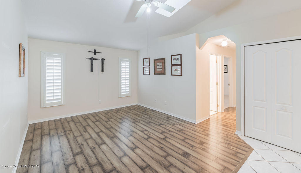 1256 Winding Meadows Road Rockledge, FL 32955 - Photo 9 of 23 an empty room with wooden floor and windows