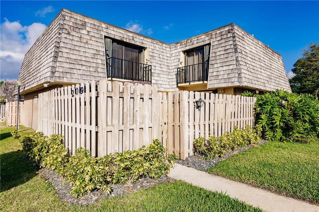 209 Woodland Road Palm Springs, FL 33461 - Photo 1 of 23 a front view of a house with a garden