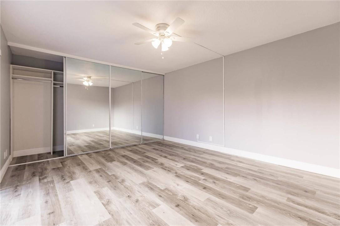 209 Woodland Road Palm Springs, FL 33461 - Photo 16 of 23 wooden floor in an empty room