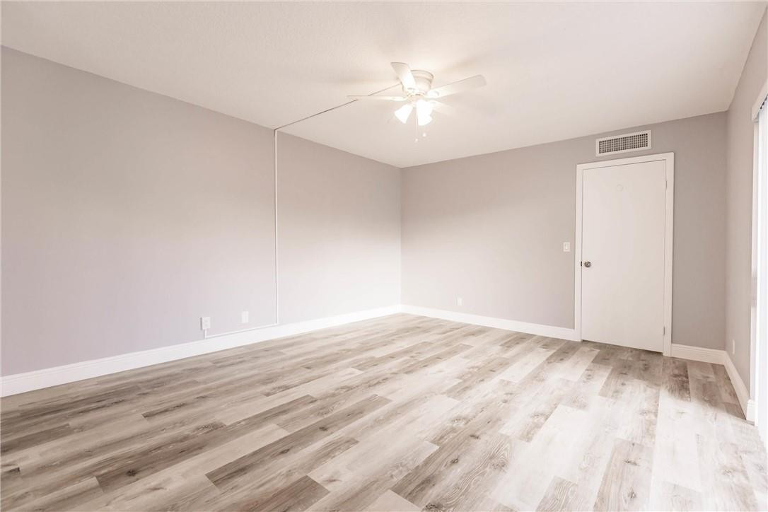 209 Woodland Road Palm Springs, FL 33461 - Photo 17 of 23 a view of an empty room with wooden floor