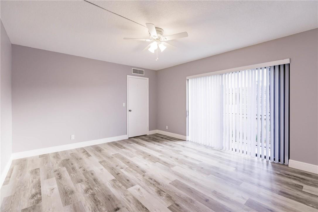 209 Woodland Road Palm Springs, FL 33461 - Photo 18 of 23 a view of an empty room with a window