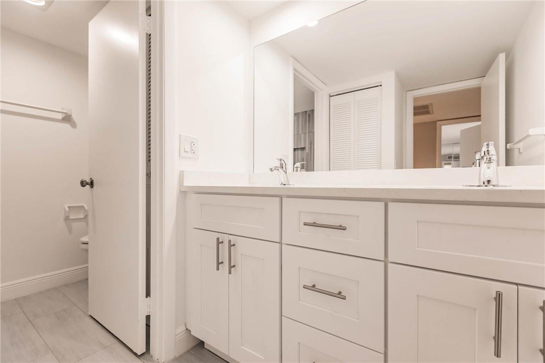 209 Woodland Road Palm Springs, FL 33461 - Photo 19 of 23 a bathroom with a sink and a mirror