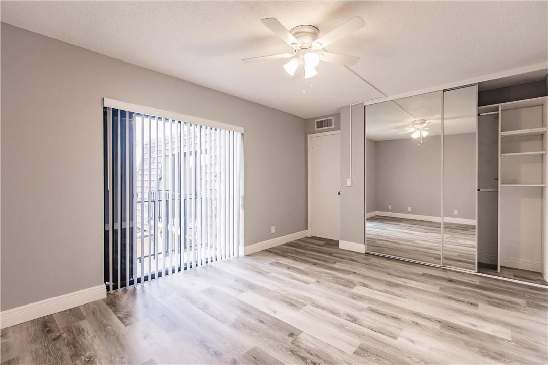 209 Woodland Road Palm Springs, FL 33461 - Photo 22 of 23 wooden floor in an empty room with a window