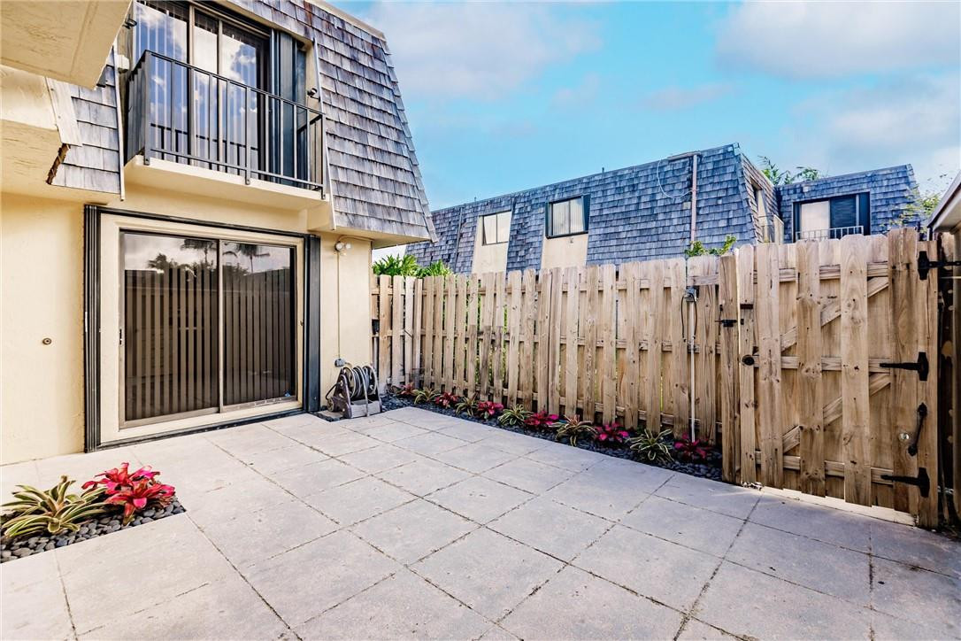 209 Woodland Road Palm Springs, FL 33461 - Photo 3 of 23 a view of a blue building with wooden fence