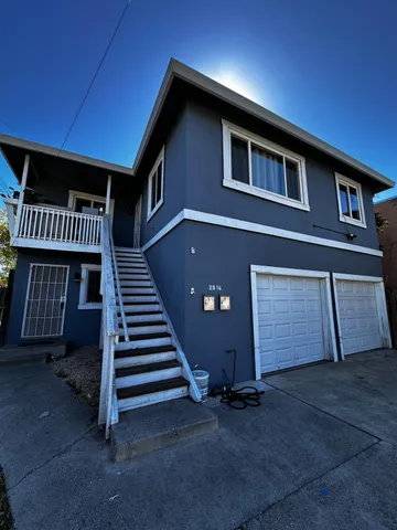 a front view of a house with stairs