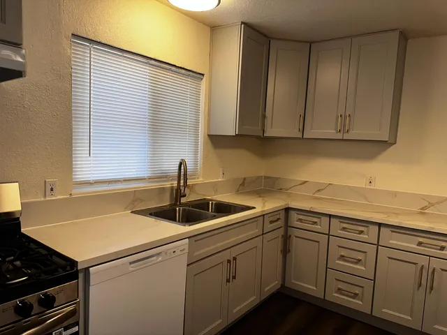 a kitchen with a sink and cabinets