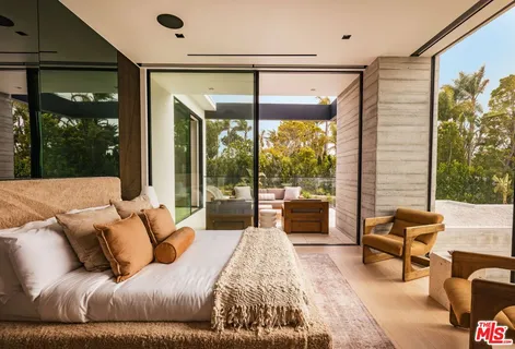 a bedroom with a large bed and a large window