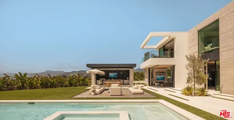 a view of an house with swimming pool and furniture