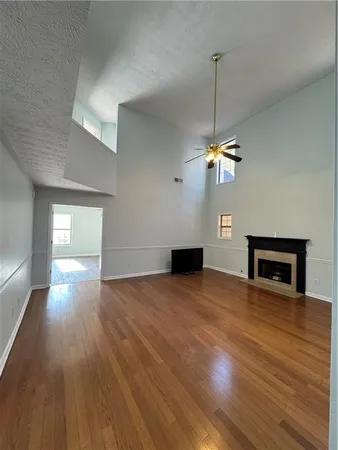 a view of a livingroom with a ceiling fan and window