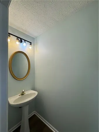 a bathroom with a sink a mirror and a toilet