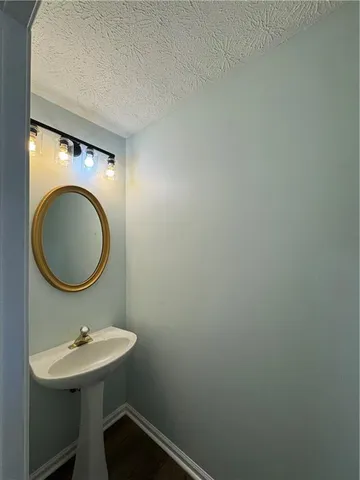 a bathroom with a sink a mirror and a toilet