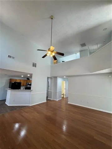 a room with lots of chandelier and wooden floor