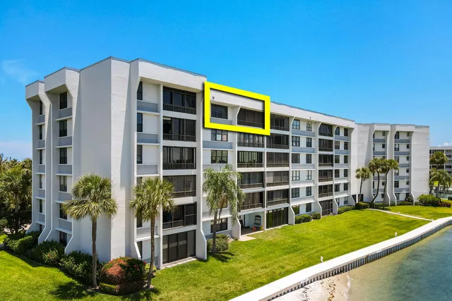 a view of a city from a balcony with furniture