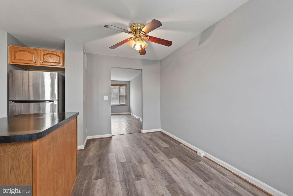 7308 Berkshire Road Baltimore, MD 21224 - Photo 14 of 40 a view of an empty room with wooden floor and a window