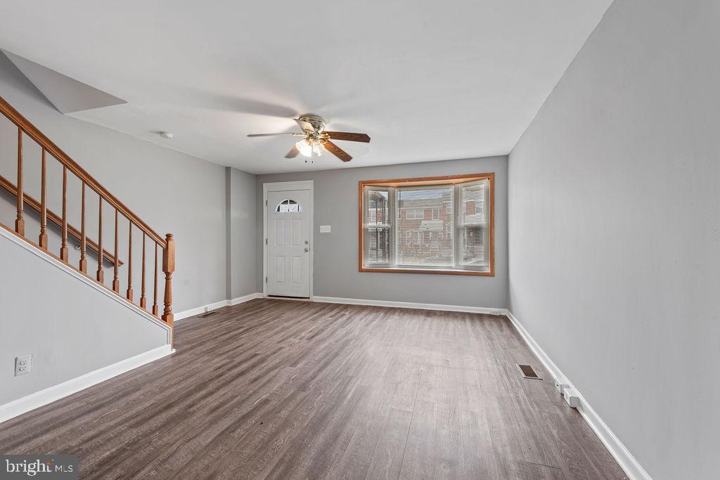 7308 Berkshire Road Baltimore, MD 21224 - Photo 15 of 40 wooden floor in an empty room with a window