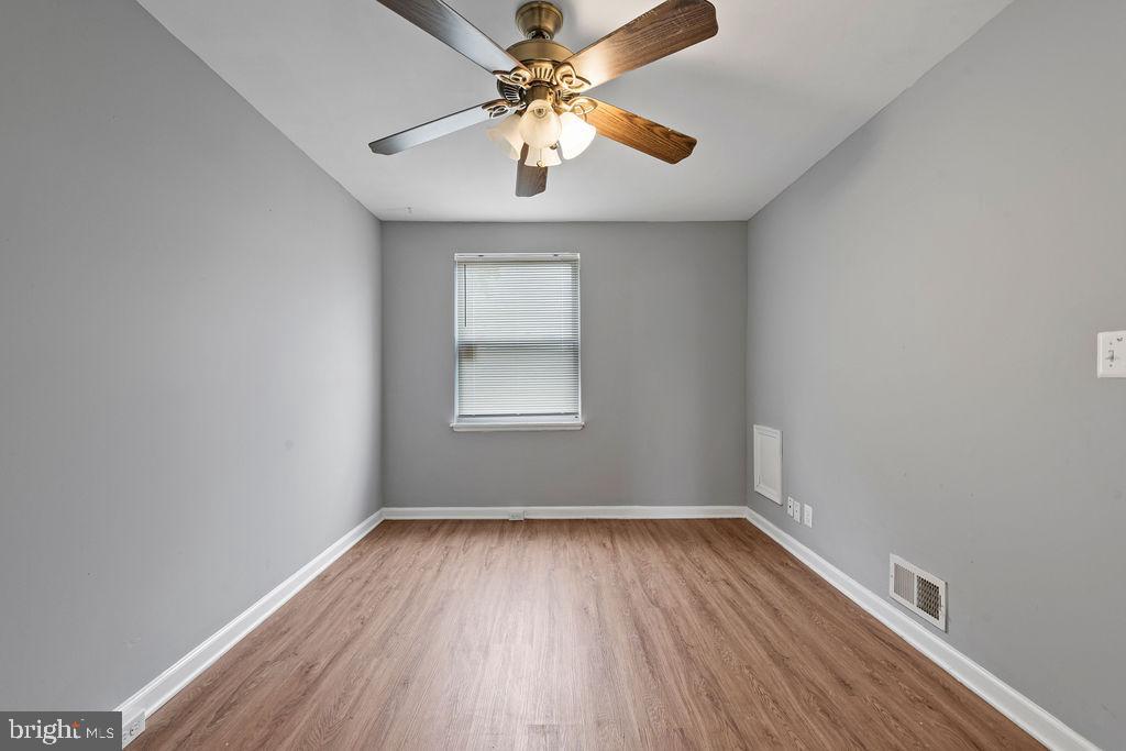 7308 Berkshire Road Baltimore, MD 21224 - Photo 20 of 40 wooden floor in an empty room with a window